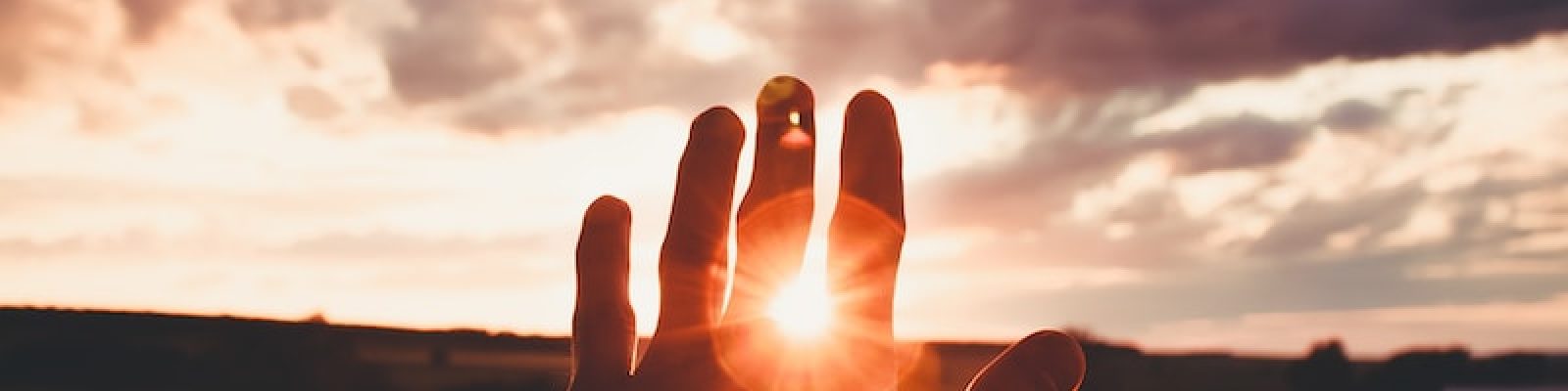 a person standing in front of a sunset