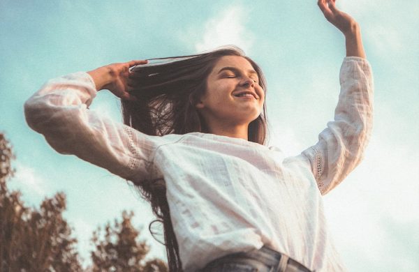 woman in white long sleeve shirt and blue denim jeans